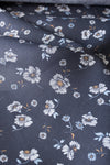 Dark navy 100% linen fabric with white daisy floral pattern, light-blue and ochre details, suitable for summer clothing