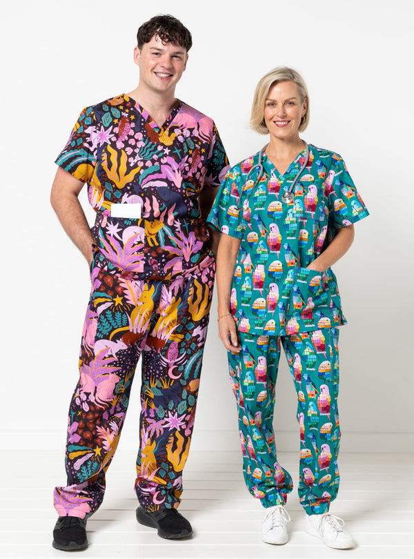 Two people wearing colorful scrubs with a white background