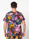 Person wearing a colorful patterned shirt with animals on a white background