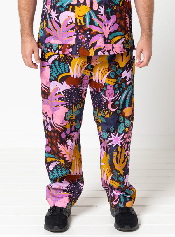 Person wearing colorful patterned pants on a white background