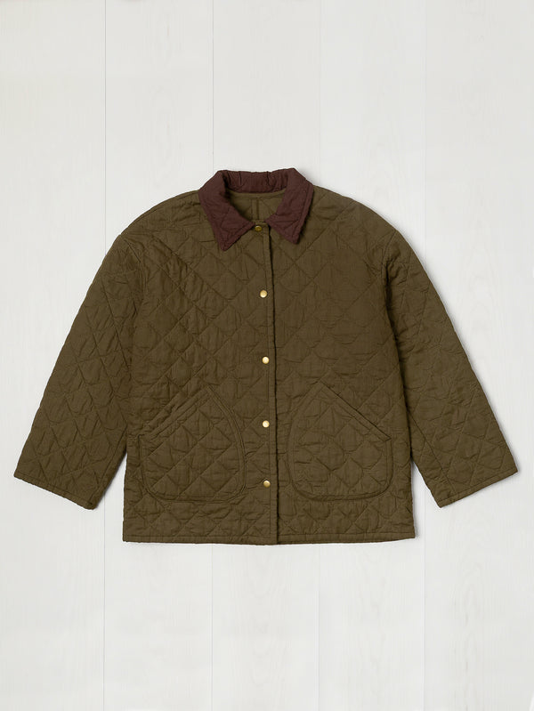 Quilted jacket with a brown collar on a white background