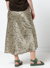 Lady wearing a Genoa Bias Cut Skirt made using the Genoa Bias Cut Skirt sewing pattern, in animal print fabric, pull-on elastic waist, ankle-length design.