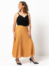 Haven Woven Skirt Sewing Pattern - mid-length skirt with fitted waist, invisible zip, flared hem with curved seams, and shaped waistband.