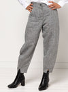 Kew Woven Pant sewing pattern, featuring a waisted, fly front design with a shaped leg, unique hem, and angled pockets, suitable for linen, fine wool, or crepe fabrics.