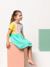 Lacey Kids Dress sewing pattern, featuring an easy slip-on design with extended shoulders, square line bodice, and slightly gathered skirt, suitable for knit or woven fabrics.