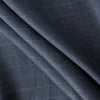 Close-up of Midnight Grid Herringbone Linen fabric with a deep navy hue, blue grid lines, and textured herringbone weave, suitable for tailored garments and home textiles.