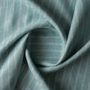 Mint Shore Stripe linen fabric with aqua–mint base, white vertical stripes and a subtle wave-like textured weave, 160 GSM