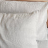 Close-up of Natural linen pillowcases on a wooden surface