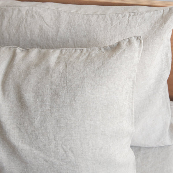 Close-up of Natural linen pillowcases on a wooden surface