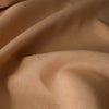 Nutmeg-colored 100% linen fabric with a fine, close weave, smooth finish, and soft drape, suitable for various dressmaking applications.