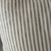 Olive Striped pillow with brown and white lines on a neutral background