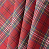 Close-up of Outback Tartan Linen fabric showcasing a vibrant red, green, blue, and yellow plaid pattern, suitable for sewing garments and home textiles.