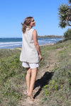 Pipit Vest Sewing Pattern - Reversible Oversized Vest in Two Lengths. woman wearing pipit vest made of natural colour linen fabric in the beach side