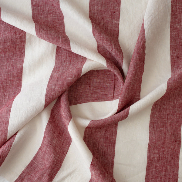 A close-up of Rosewood Broadstripe fabric with alternating wide cream and muted dusty rose vertical bands, showing a textured woven surface.