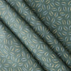 Sage Coast Print linen fabric with small botanical leaf motifs on a muted blue–green base