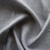 Seamist 100% Linen Fabric with a unique denim-like twill weave in greenish-grey. Features purplish grey and green warp fibers with white weft fibers, perfect for sturdy garments like jackets, pants, structured dresses, and skirts. Soft, smooth hand, tight weave, and heavy drape.