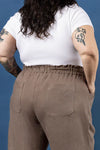Person wearing a white t-shirt and brown pants made using Sepia Pants and Shorts sewing patternagainst a blue background