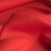 Vibrant Shocking Red linen fabric with a smooth texture and medium drape, ideal for crafting statement fashion pieces.