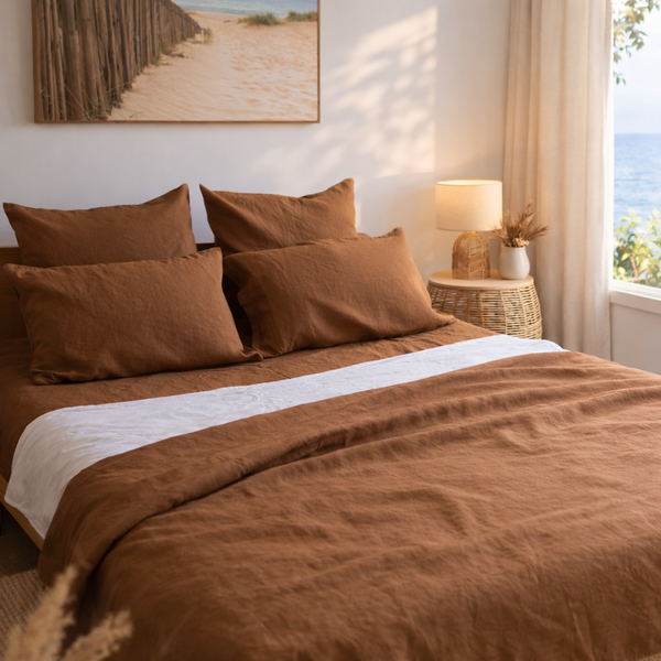 Bedroom with Tobacco Brown bedding and a lamp on a nightstand.