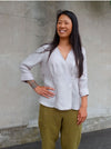 Style Arc’s Vera Woven Blouse pattern with feminine wrap front, pleats, and long sleeves.