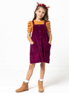 Style Arc’s Zoe Kids Pinafore pattern with button-through front and adjustable shoulder straps.