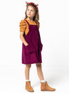 Style Arc’s Zoe Kids Pinafore pattern with button-through front and adjustable shoulder straps.