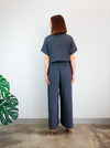 Stylish Eadie Woven Jumpsuit/Dress and Norman Jumpsuit pattern with extended shoulder line, wide legs, and front split skirt, offering a contemporary look.