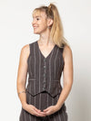 Joy Woven Vest sewing pattern featuring faux welt pockets, princess line, button opening with four buttons, cutaway at center back, easy fit, and fully lined, suitable for linen and cotton fabrics.