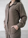 A trendy Melrose boiler suit sewing pattern with a button fly front, long sleeves, and practical pockets, suitable for durable fabrics like denim and linen.