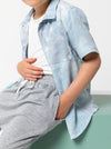 Kids’ Rhys Overshirt sewing pattern with button front, collar, short sleeves, and breast pocket, perfect for cotton or linen fabrics